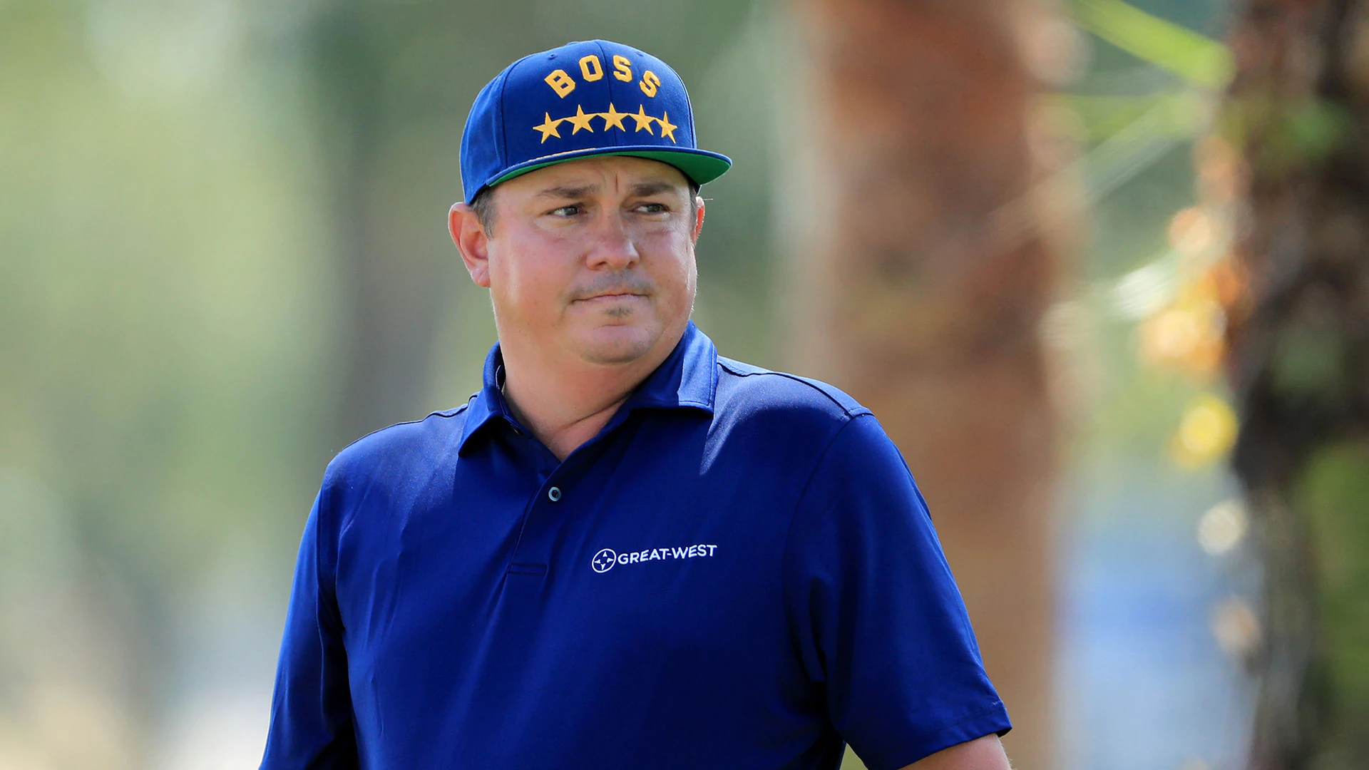 Dufner wears &quot;BOSS&quot; hat while playing with Tiger
