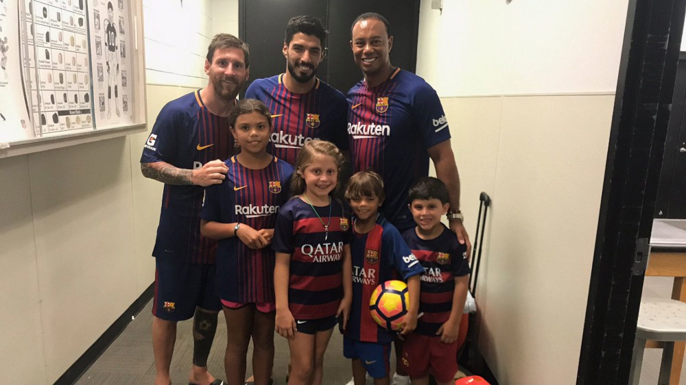 Tiger, kids visit soccer stars Messi, Suarez