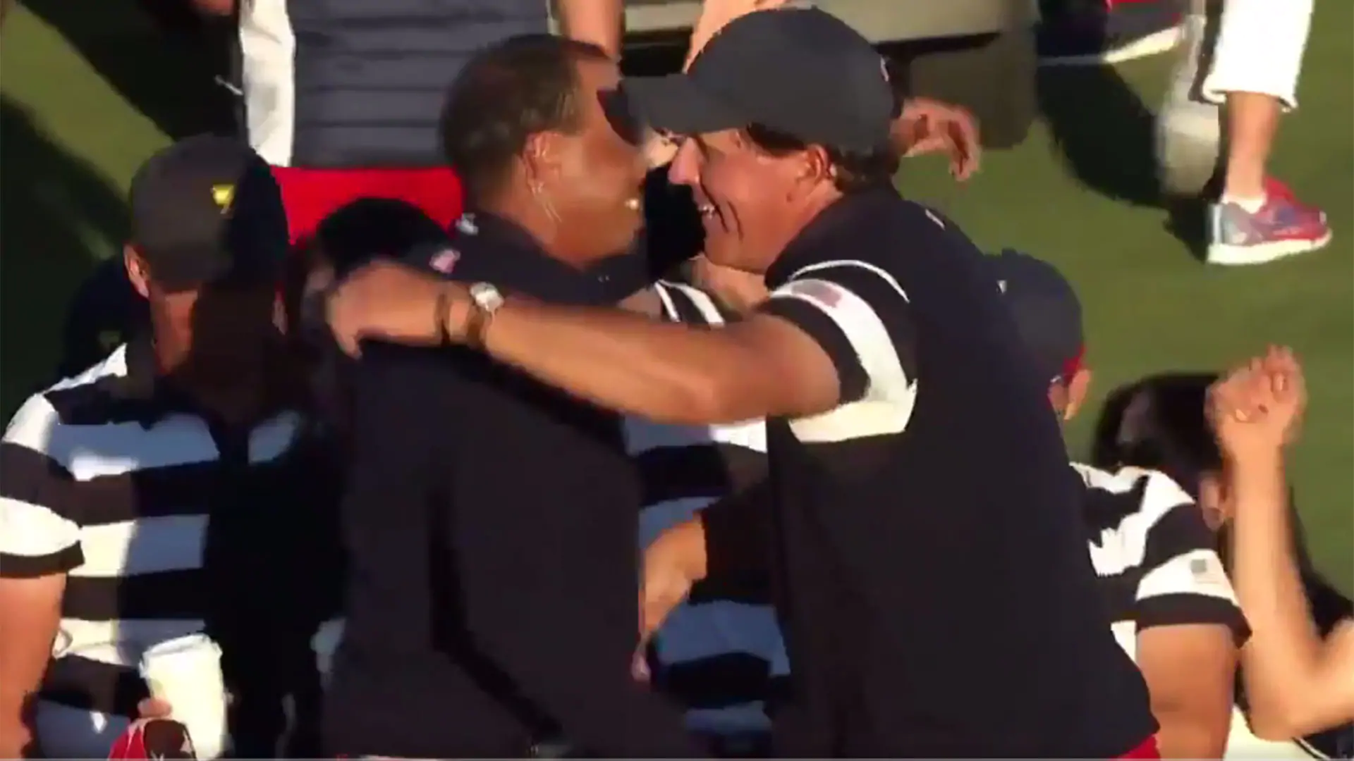 Watch: Tiger gives Phil big hug after win
