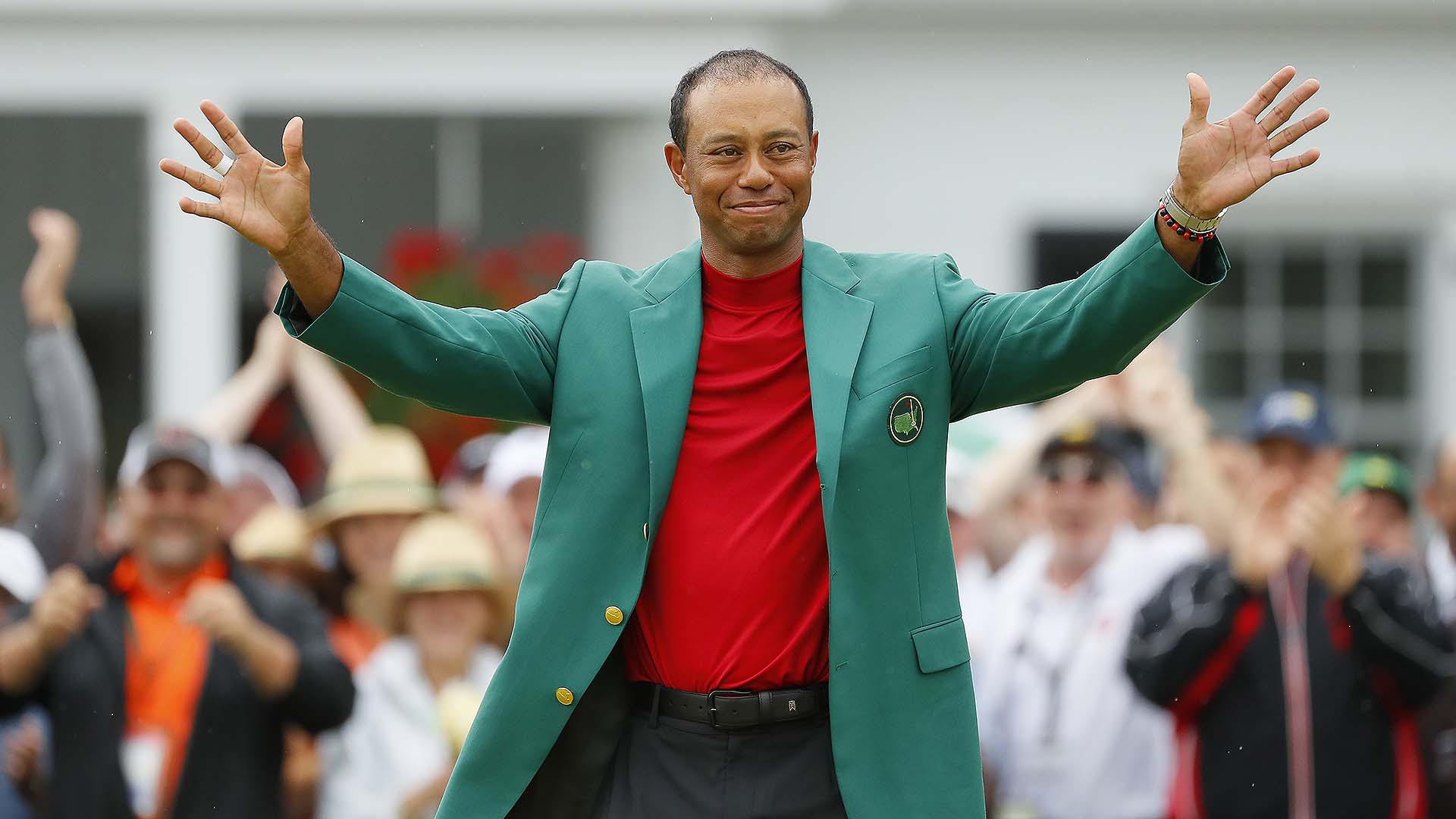 Tiger Woods touched by players showing their support by wearing red